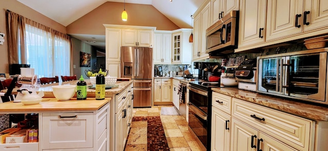 149 Oak, Cresco, PA 18326 - kitchen featuring stainless steel appliances, decorative backsplash, vaulted ceiling, cream cabinetry, and butcher block counters