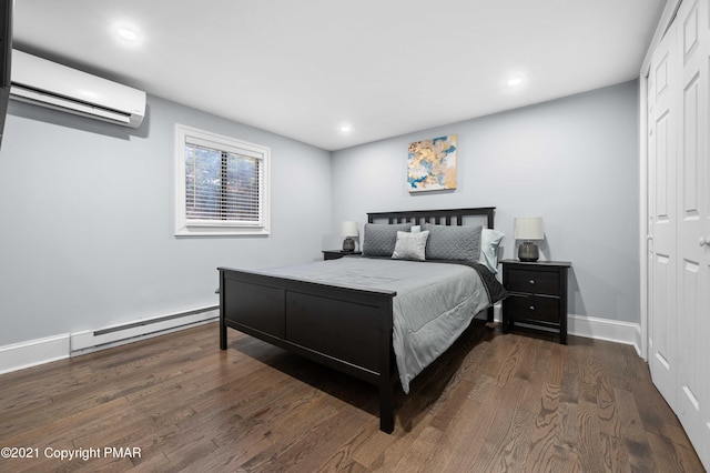11 Middle Village Way, Tannersville, PA 18372 - bedroom with a closet, a baseboard heating unit, wood finished floors, and a wall mounted AC