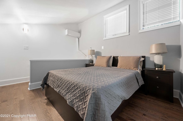 11 Middle Village Way, Tannersville, PA 18372 - bedroom with baseboards, an AC wall unit, and wood finished floors
