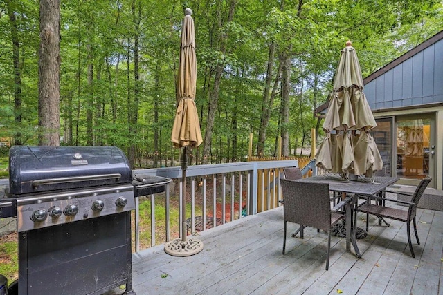 348 Fernwood Dr, East Stroudsburg, PA 18301 - deck with area for grilling, outdoor dining area, and a forest view