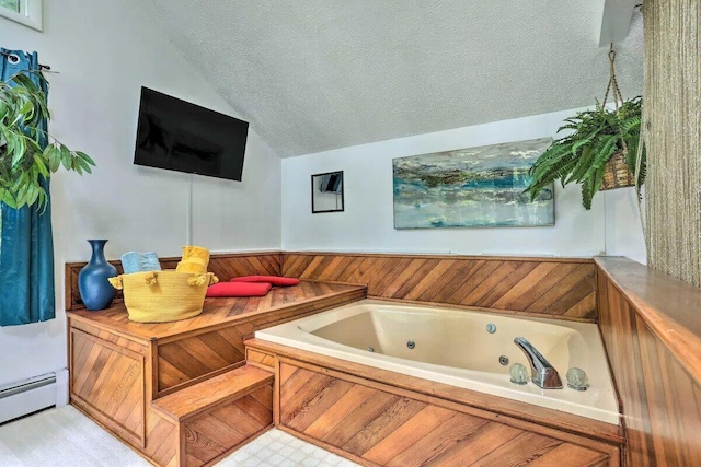 348 Fernwood Dr, East Stroudsburg, PA 18301 - bathroom with lofted ceiling, baseboard heating, a jetted tub, and a textured ceiling