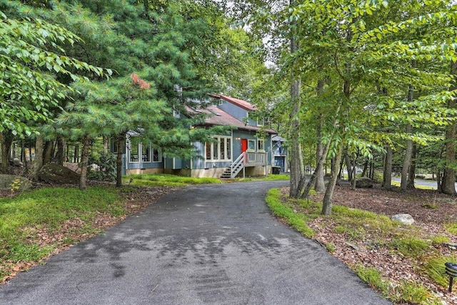 348 Fernwood Dr, East Stroudsburg, PA 18301 - view of property hidden behind natural elements with asphalt driveway