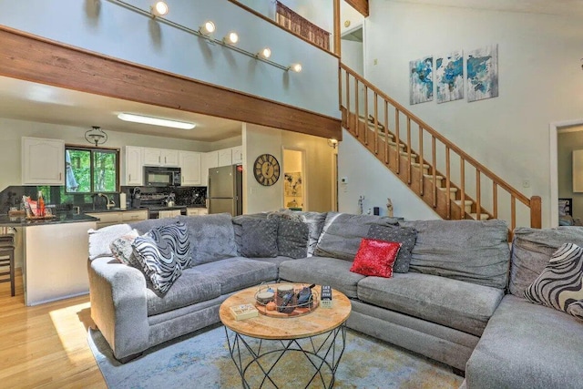 348 Fernwood Dr, East Stroudsburg, PA 18301 - living room featuring light wood-style floors, stairs, and a high ceiling