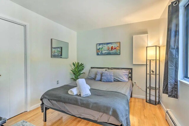 348 Fernwood Dr, East Stroudsburg, PA 18301 - bedroom featuring baseboard heating and light wood finished floors