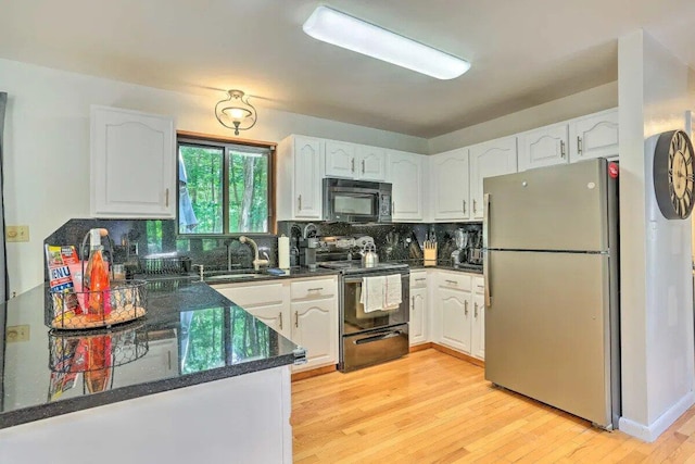 348 Fernwood Dr, East Stroudsburg, PA 18301 - kitchen with black appliances, dark countertops, and white cabinetry