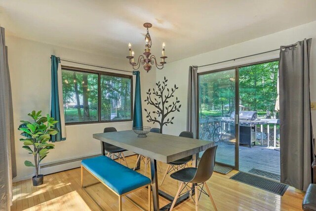 348 Fernwood Dr, East Stroudsburg, PA 18301 - dining space with a chandelier, light wood-type flooring, and a baseboard radiator