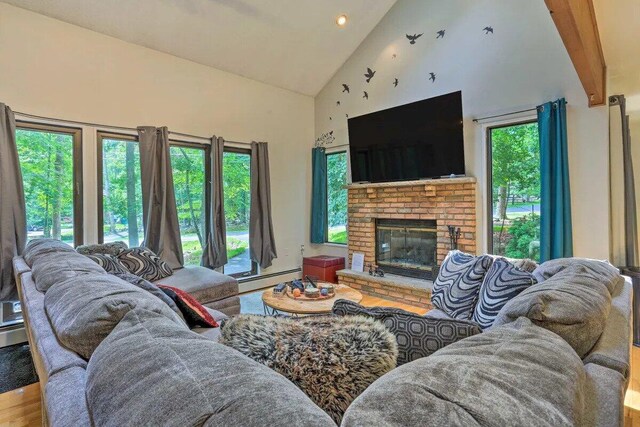 348 Fernwood Dr, East Stroudsburg, PA 18301 - living room featuring high vaulted ceiling, a fireplace, wood finished floors, a baseboard radiator, and recessed lighting