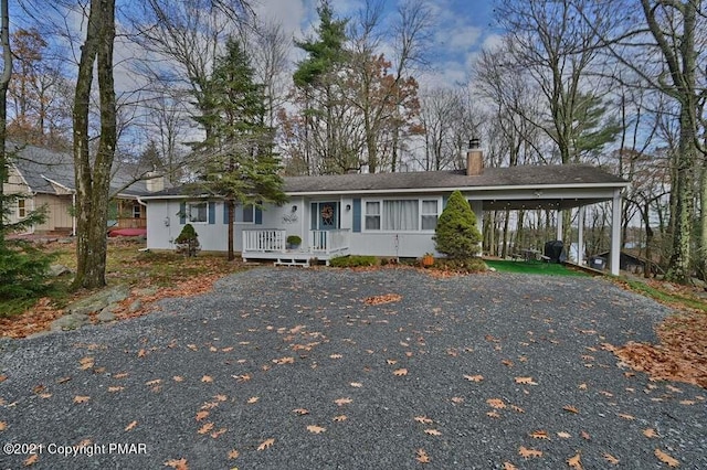 36 Maplewood Rd, Lake Harmony, PA 18624 - single story home featuring a chimney, driveway, and a carport