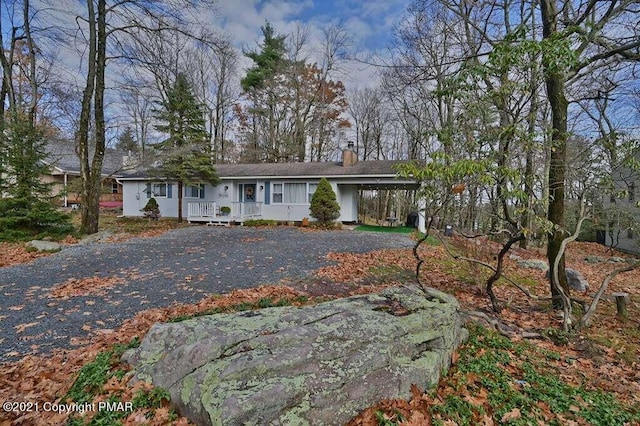 36 Maplewood Rd, Lake Harmony, PA 18624 - single story home featuring covered porch, a chimney, asphalt driveway, and a carport