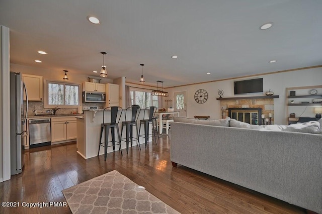 36 Maplewood Rd, Lake Harmony, PA 18624 - living room with plenty of natural light, dark wood-type flooring, recessed lighting, a fireplace, and ornamental molding