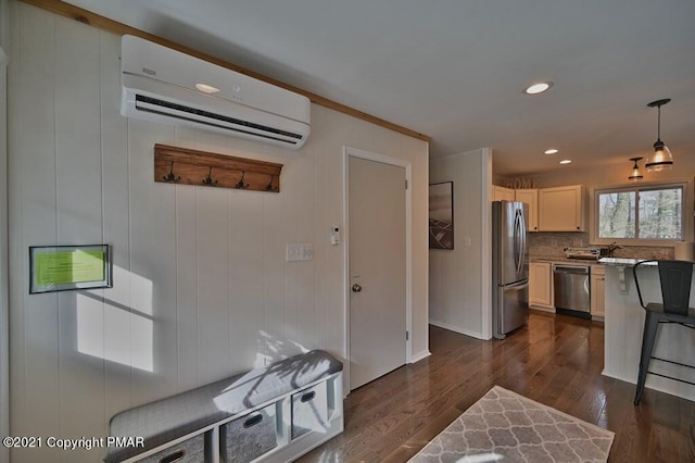 36 Maplewood Rd, Lake Harmony, PA 18624 - kitchen with stainless steel appliances, a wall mounted air conditioner, dark wood-type flooring, tasteful backsplash, and hanging light fixtures