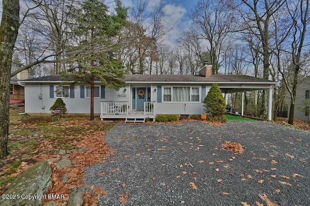 36 Maplewood Rd, Lake Harmony, PA 18624 - ranch-style home with a chimney, an attached carport, driveway, and roof with shingles
