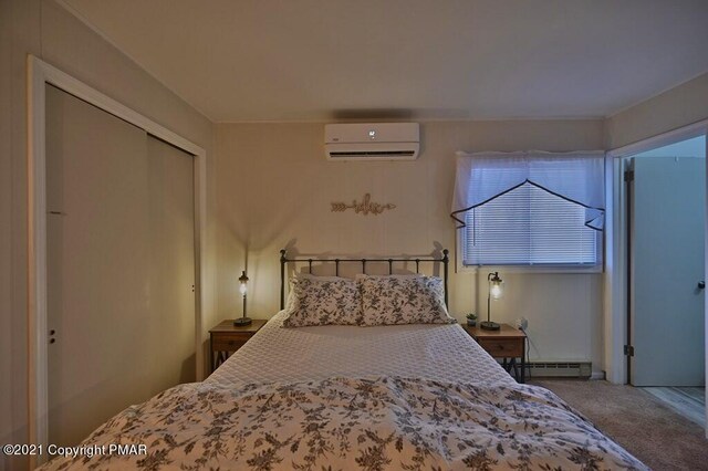36 Maplewood Rd, Lake Harmony, PA 18624 - bedroom featuring a wall mounted air conditioner, a baseboard radiator, carpet, and a closet