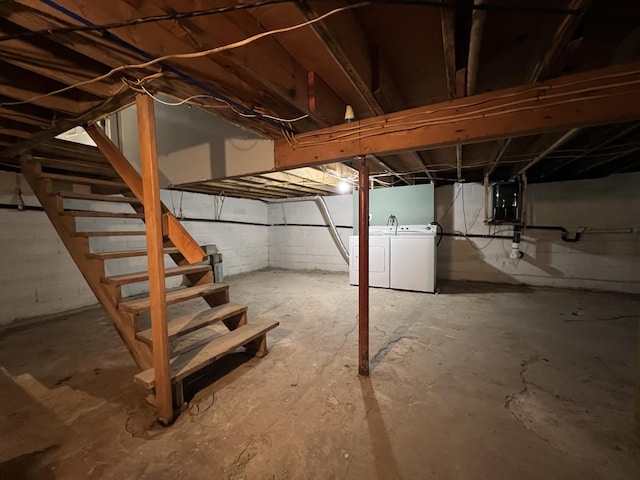 unfinished basement with separate washer and dryer and stairway