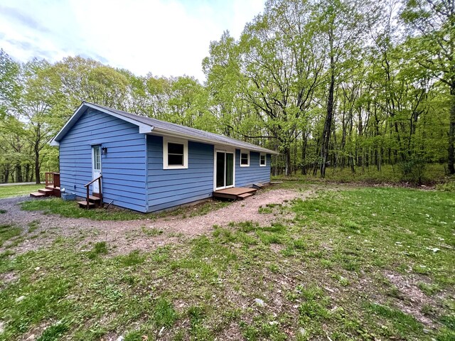 rear view of property featuring a deck