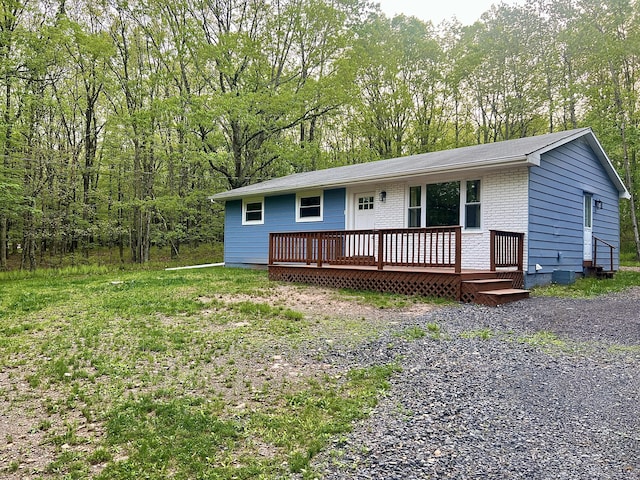 view of front of home with a wooden deck and brick siding