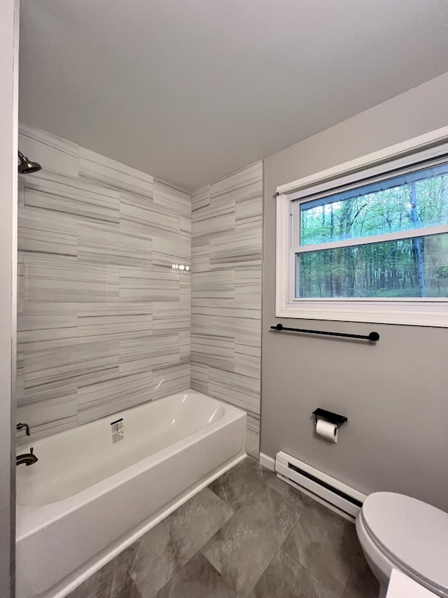 bathroom featuring a baseboard heating unit, toilet, plenty of natural light, and baseboards