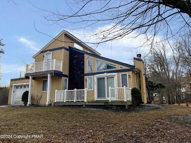 view of front of home with a chimney, an attached garage, and a balcony