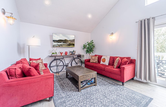 living area featuring vaulted ceiling, wood finished floors, and recessed lighting