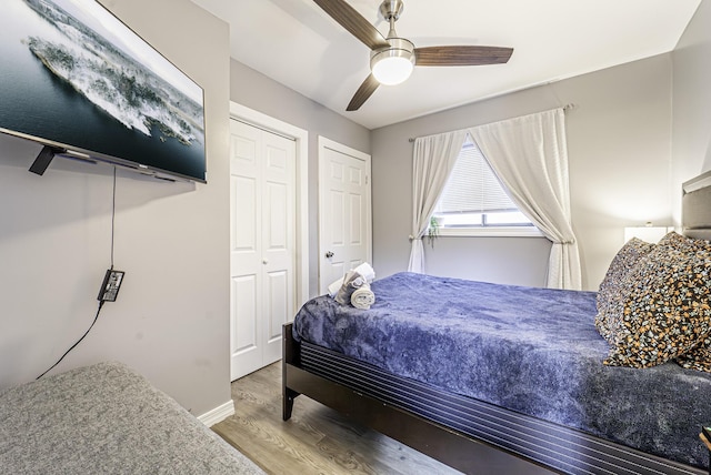 bedroom featuring ceiling fan, baseboards, and wood finished floors