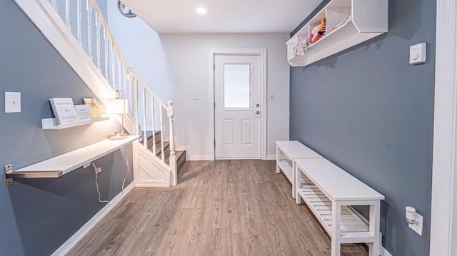 mudroom featuring baseboards and wood finished floors