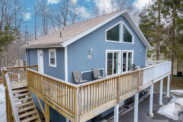 back of house with a shingled roof and a wooden deck