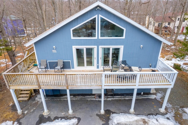 back of property with a wooden deck