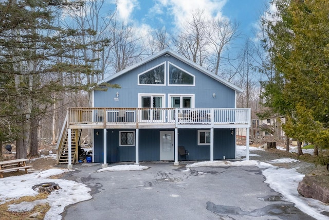 view of front of house with stairway and a wooden deck