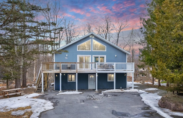 view of front of property featuring stairway and a wooden deck