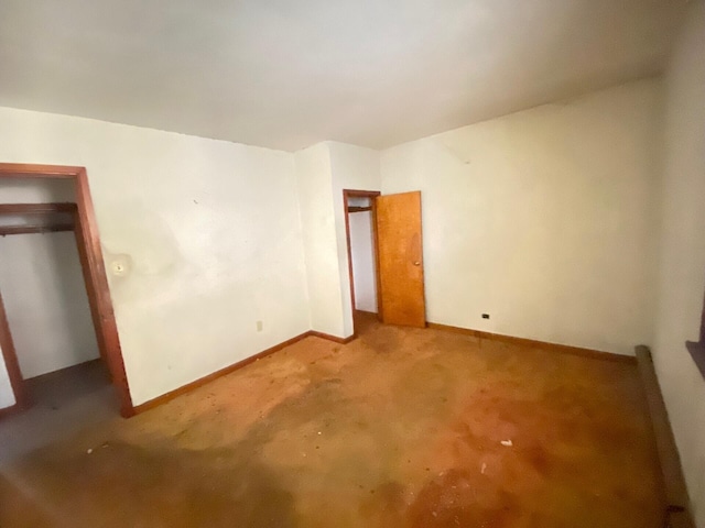 unfurnished bedroom featuring carpet and baseboards