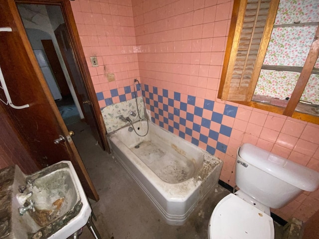 bathroom featuring toilet, a shower stall, and tile walls