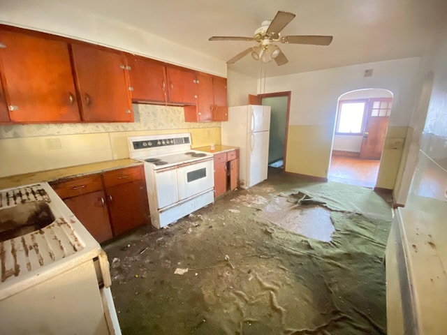 kitchen featuring white appliances, decorative backsplash, brown cabinets, light countertops, and a sink