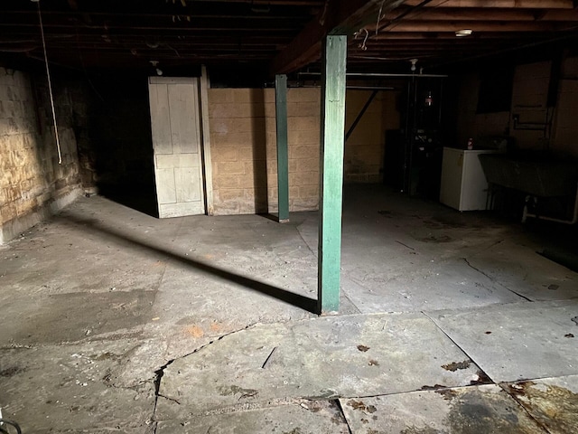 basement featuring washer / dryer and a sink