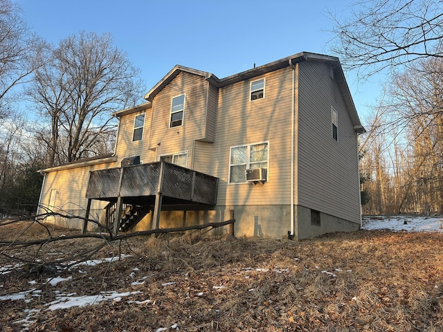 rear view of house featuring stairs, cooling unit, and a wooden deck