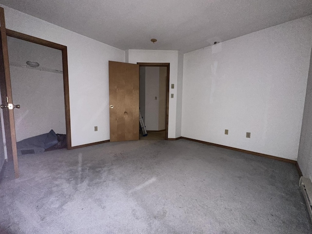 unfurnished bedroom featuring baseboards and carpet floors