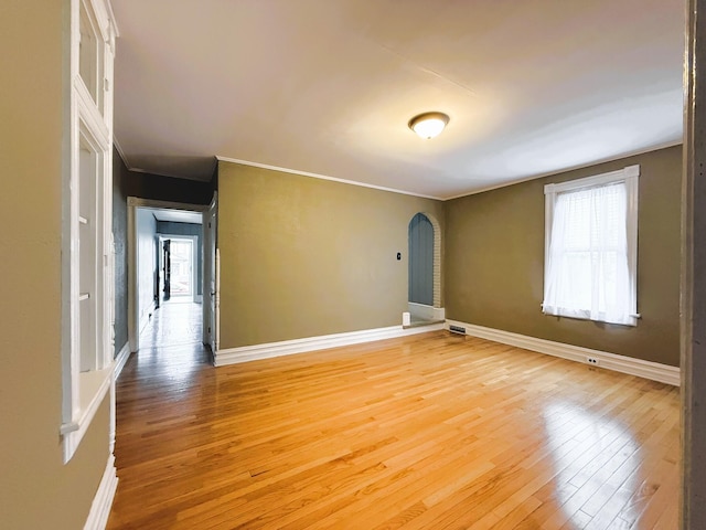 233 Lafayette Ave, Palmerton, PA 18071 - empty room featuring light wood-style floors, arched walkways, and crown molding