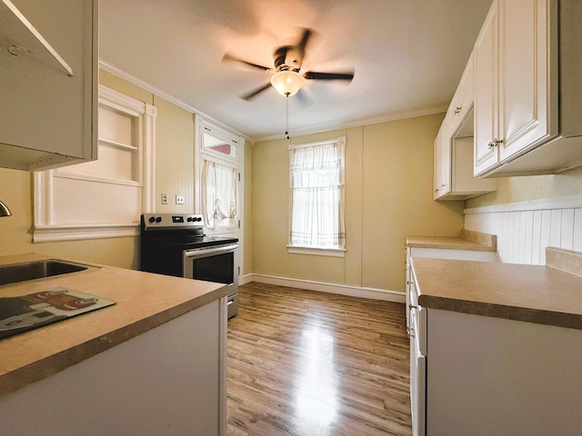 233 Lafayette Ave, Palmerton, PA 18071 - kitchen featuring stainless steel electric range, crown molding, light wood finished floors, a ceiling fan, and white cabinetry