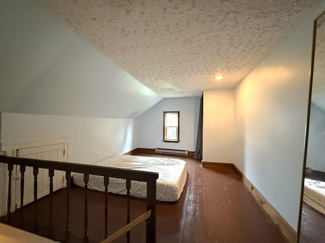 233 Lafayette Ave, Palmerton, PA 18071 - unfurnished bedroom with baseboard heating, lofted ceiling, a textured ceiling, and hardwood / wood-style flooring