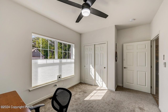 interior space featuring carpet, ceiling fan, and baseboards