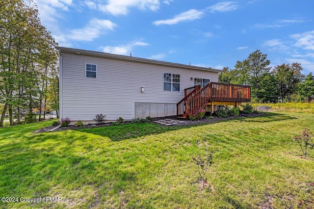 back of house with a wooden deck, stairway, and a yard