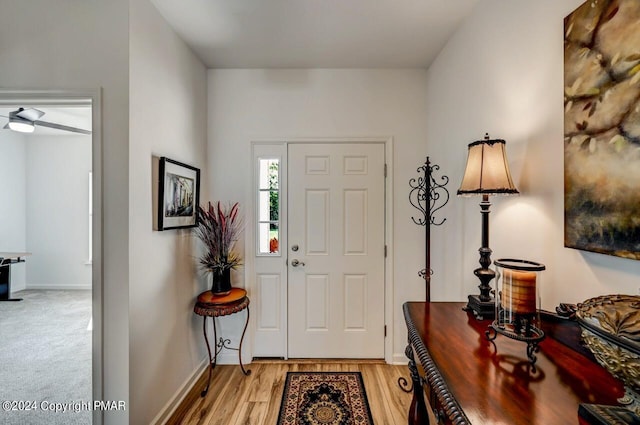 foyer with light wood-type flooring and baseboards