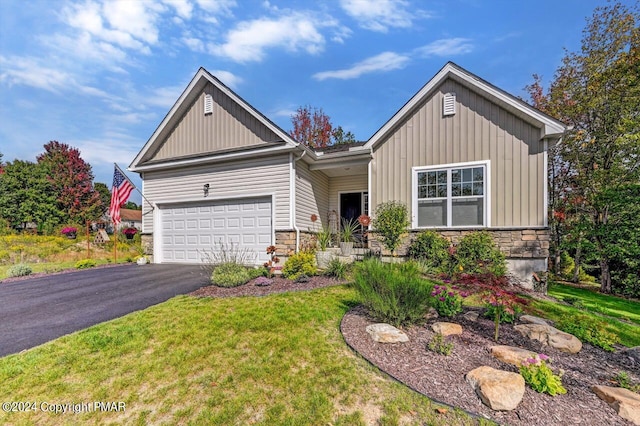 view of front of home with a garage, stone siding, aphalt driveway, and board and batten siding