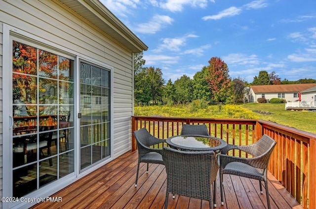 wooden terrace with outdoor dining space