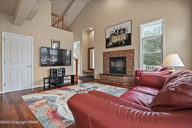 living area with high vaulted ceiling, a stone fireplace, baseboards, beamed ceiling, and dark wood finished floors