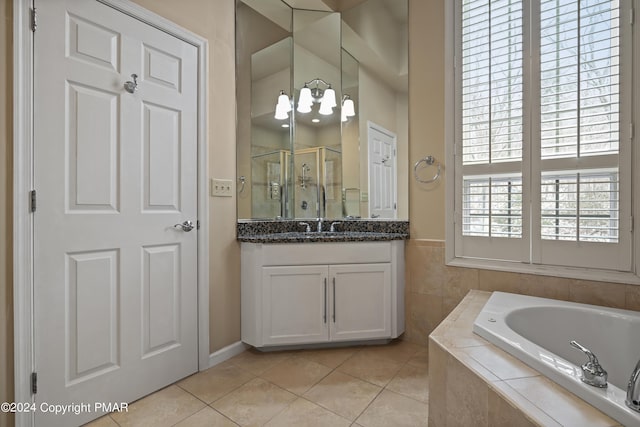 full bath with a stall shower, tile patterned floors, vanity, and a bath