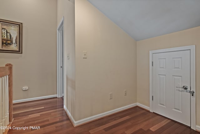 interior space featuring vaulted ceiling, baseboards, and wood finished floors