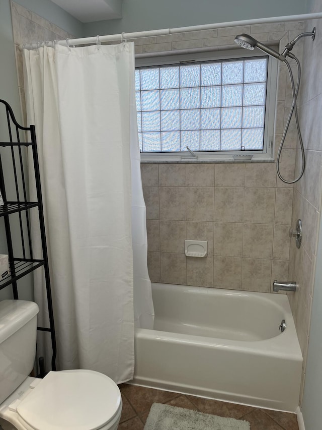 bathroom with shower / tub combo, toilet, and tile patterned floors