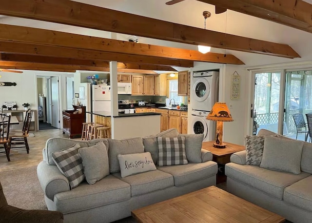 living room with lofted ceiling with beams, baseboard heating, and a ceiling fan