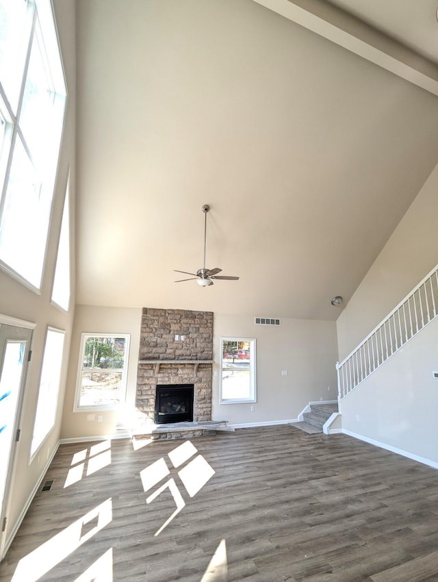251 Bellingham Dr, Bushkill, PA 18324 - unfurnished living room with high vaulted ceiling, ceiling fan, stairs, plenty of natural light, and a fireplace