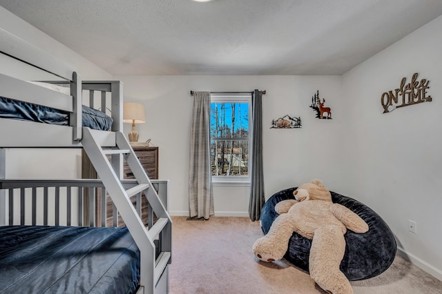 carpeted bedroom with baseboards and a textured ceiling